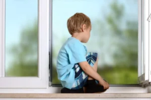 child sitting in window