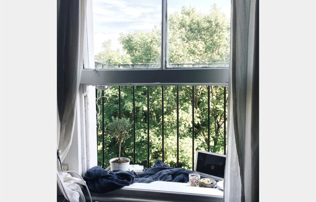 Bedroom-with-burglar-bars-laptop-by-window