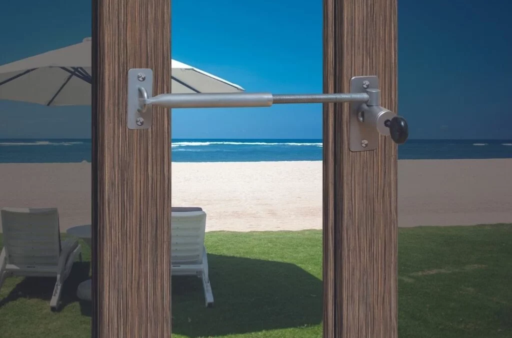 locklatch keeping doors open with a view of the beach.